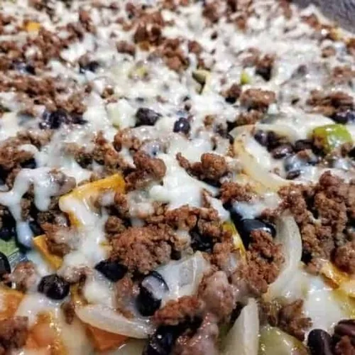 Loaded sweet potato nachos on an aluminum baking sheet.