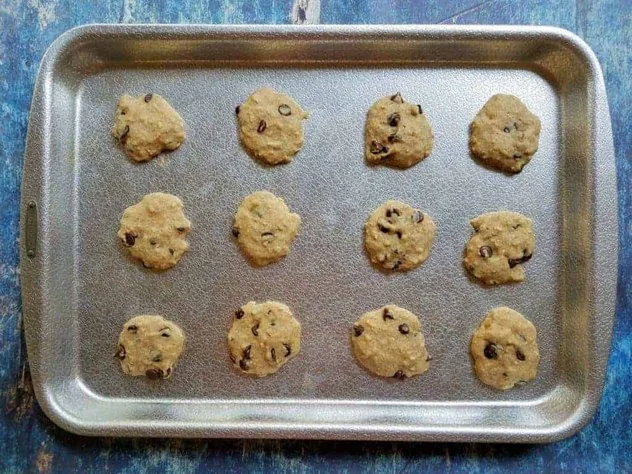 Chocolate Chip Oatmeal Pulp Cookies Process Step 5 Freshly baked chocolate chip oatmeal pulp cookies on an aluminum baking sheet.