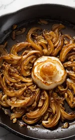 Close-up of finished caramelized onions on a white plate. This is the designated Pinterest pin