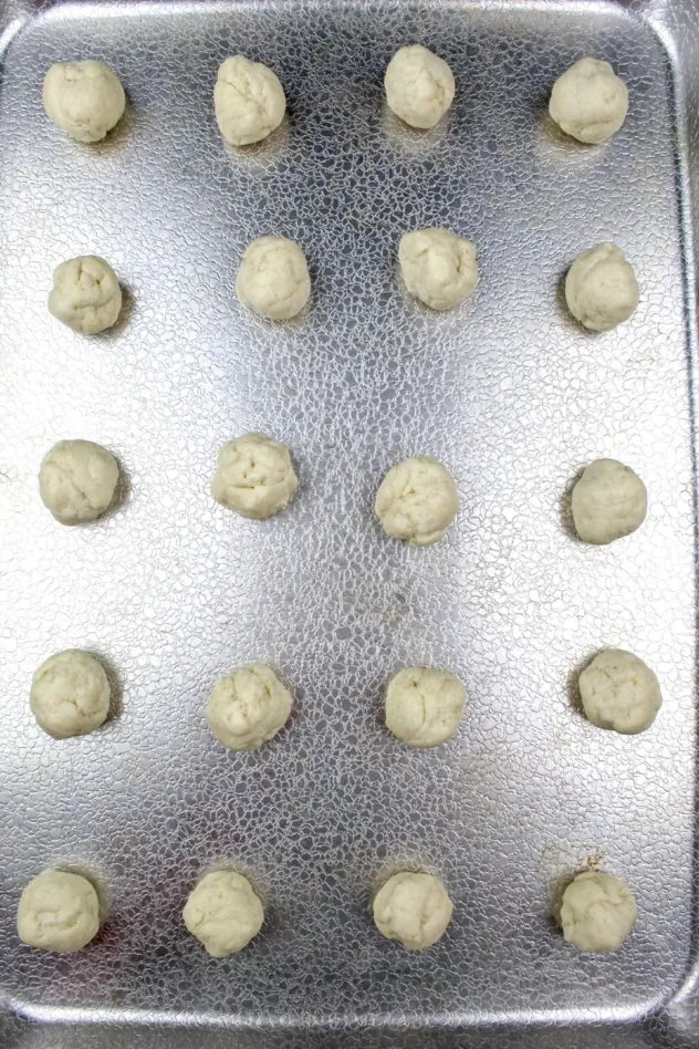 Gluten-Free Ricotta Cookies Process Step 4a 20 tablespoon sized drops of dough on a texture aluminum baking sheet prior to baking.