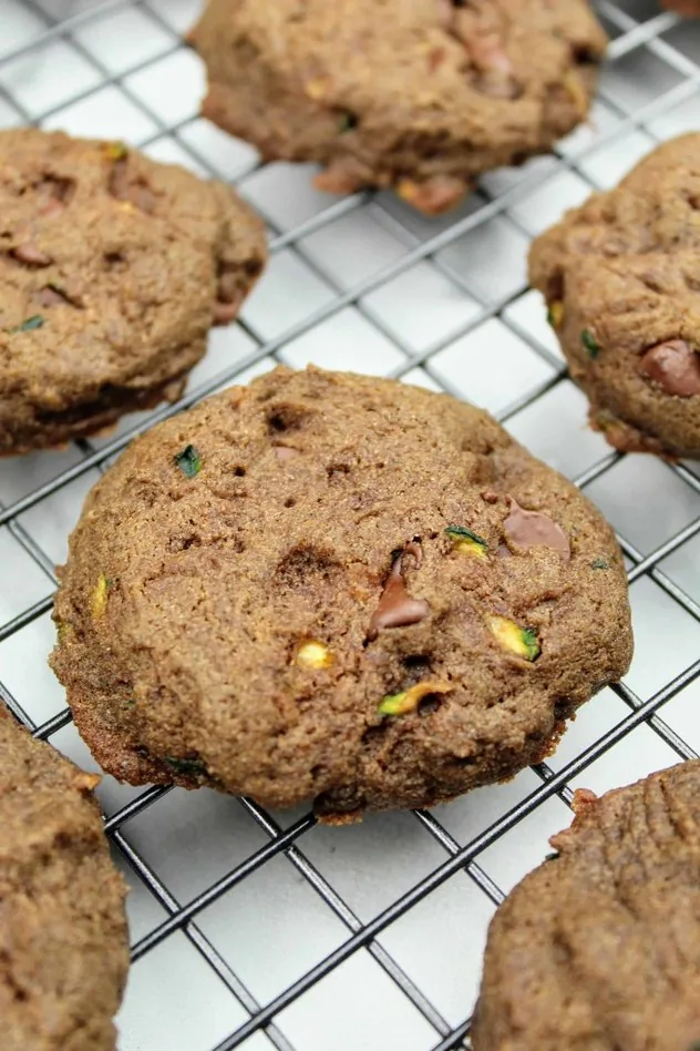 Vegan chocolate zucchini cookies arranged on a wire cooling rack.