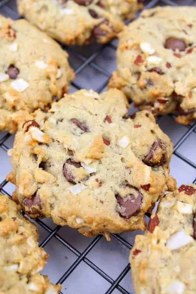 Baked vegan almond coconut chocolate chip cookies cooling on a wire rack.
