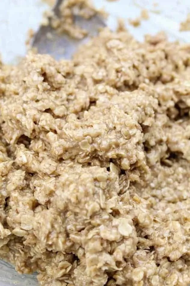 The addition of gluten-free flour to the mixture to make the vegan oatmeal raisin cookie dough.