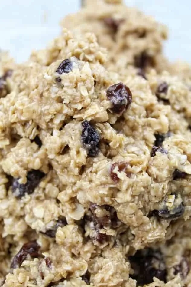 The addition of raisins to the dough to complete the vegan oatmeal raisin cookie dough.
