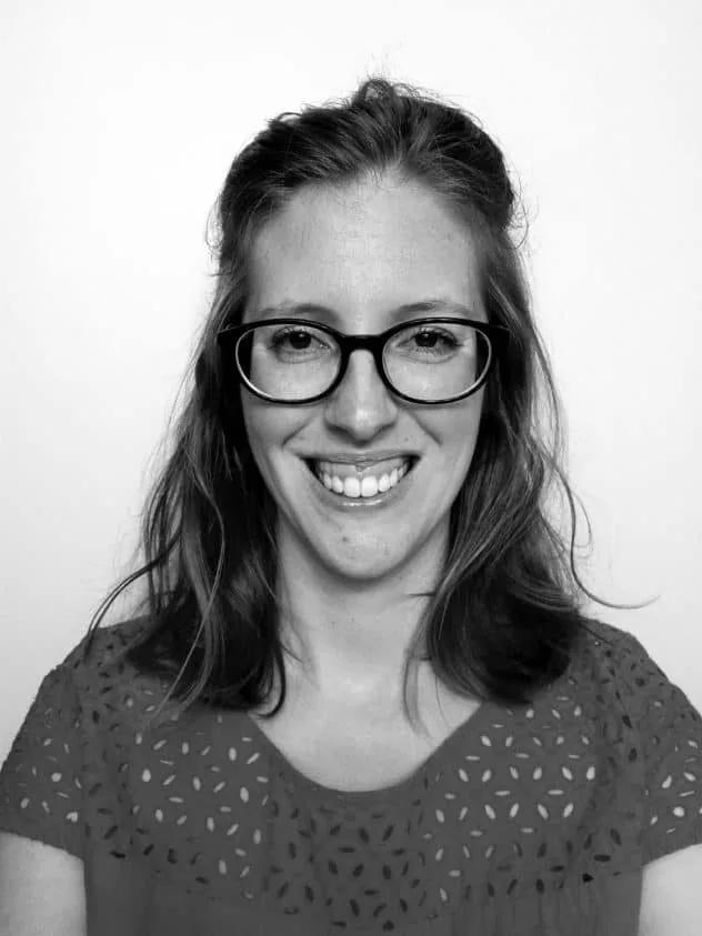 An above the shoulders black and white photo of me. I have shoulder length hair and circular black rim glasses on.